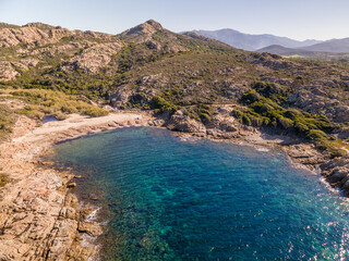 Fototapeta na wymiar Rocky coastline and small sandy beach near Ostriconi in Corsica