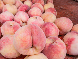 Close up chinese peach fruits on the basket in the fruits store at china