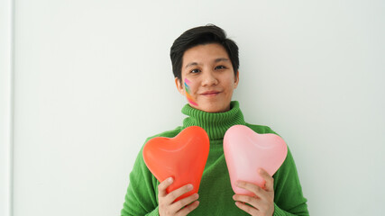 Romantic happy love Asian gay woman happy holding heart symbol