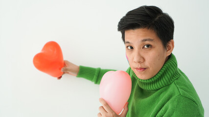 Romantic happy love Asian gay woman happy holding heart symbol