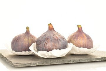 Obraz premium Ripe dark blue organic figs, close-up, on a white background.