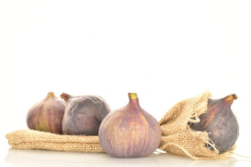 Fototapeta premium Ripe dark blue organic figs, close-up, on a white background.