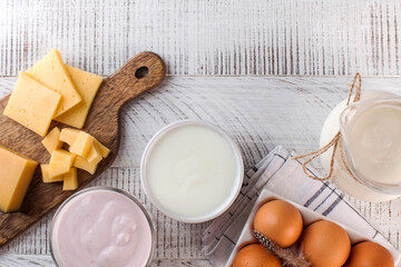 Flatlay a variety of dairy products, cheese, farm eggs. The concept of the farmer's market. Copy space.