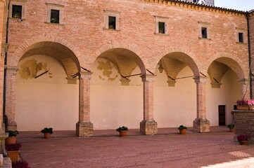 The colonnade of the inner courtyard of a medieval Italian abbey (Gubbio, Umbria, Italy)