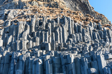 Black basalt columns of Reynisfjara, famous black-sand beach in the South Coast of Iceland....