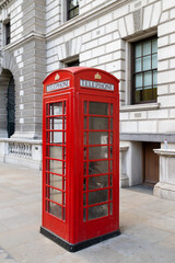 Red iconic telephone booth on the street