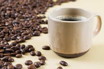 Coffee cup and coffee beans on the table
