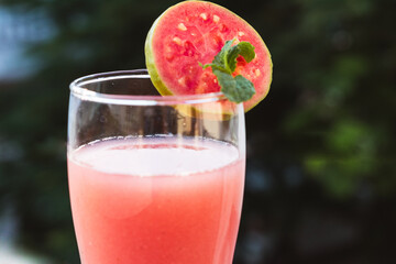 Close up shot of glass of organic Guava juice with fresh guava