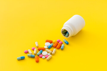 Heap of pills with drug bottle close up