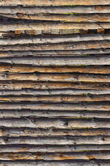Wooden fence. Wooden trunks. A row of wooden posts. Wood texture. Wood trunk surface texture. Surface of wooden branches