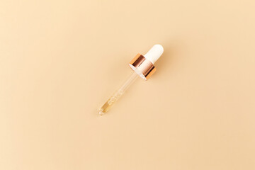 Serum with pipette on beige background. Top view, flat lay. Concept skincare. Dermatology science cosmetic laboratory. Natural medicine, cosmetic research, organic skin care products.