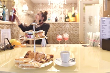 pastries and coffee on the counter of a deluxe bar