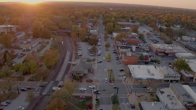Aerial of intersection at train station in downtown Kirkwood, Missouri at sunset in the Fall.