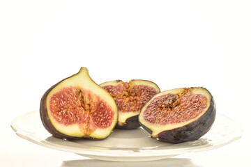 Ripe dark blue organic figs, close-up, on a white background.