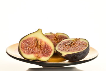 Ripe dark blue organic figs, close-up, on a white background.