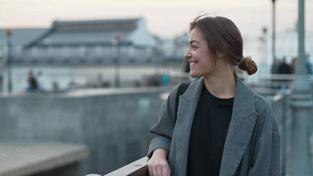 Young woman look at the camera, smiles and laughs