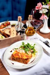 Lasagne bolognese in a plate on a table