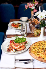 Fried shrimps and pizza on a table