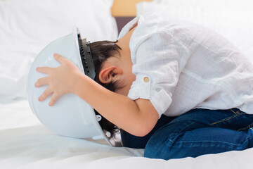 Boy in white safety helmet very happy and funny at home.