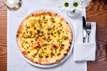 Pizza in a plate on a table.