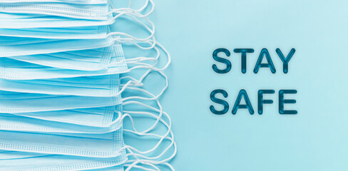 Pandemic  personal protective equipment, text STAY SAFE.  COVID-19 SARS-COV-2 Blue banner background. Copy space.
