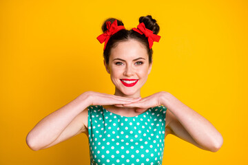 Close-up portrait of pretty cheerful girl showing good bright makeover isolated over vibrant yellow color background
