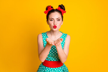Portrait of nice charming lovable girl sending you air kiss red lips isolated over vibrant yellow color background