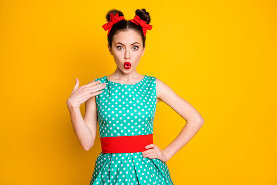 Portrait of nice pretty cute amazed wondered girl wearing dotted dress pouted lips isolated over vibrant yellow color background