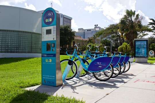 9/19/2019 West Palm Beach FL-Bright blue nextbike bicycles with Skybike WPB logos in public sidewalk area for individual or group rentals for sightseeing around downtown West Palm Beach FL