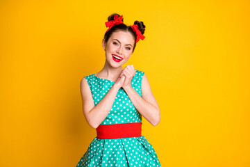 Portrait of nice charming sweet cheerful girl wearing teal dress enjoying party isolated over vibrant yellow color background