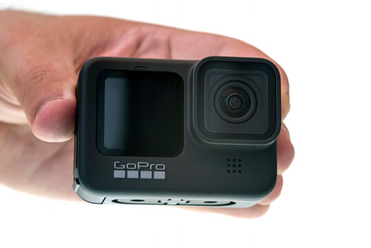 Hand holding compact action camera