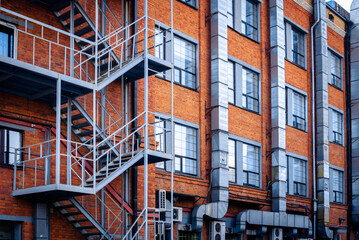 The facade of a brick building with a fire escape.