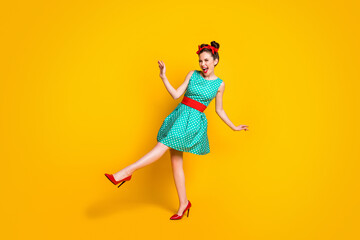 Full length body size view of lovely glad cheerful girl dancing having fun enjoying disco clubbing isolated on bright yellow color background © deagreez