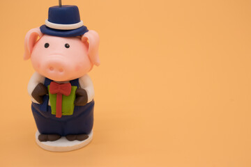 Christmas toy in the form of a pig isolated on yellow background