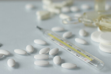 Medicines on a white background. Coronavirus treatment and protection. Vaccine, antibiotics, vitamins. Tablets and capsules. About health and protection.