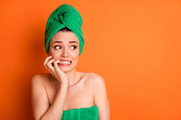 Photo portrait of scared woman biting fingers nails looking at blank space isolated on bright...
