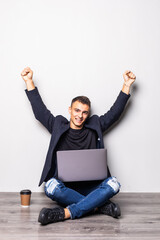 Successful young man holding his laptop on his laptop, isolated on white background