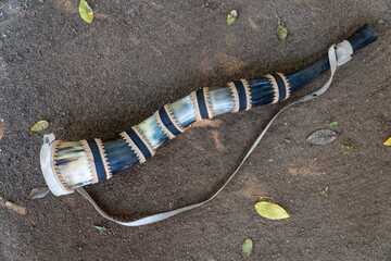 Close up of handmade blowing horn, berrante , from Pantanal. The rustic instrument is used to blow loud warning sounds by cowboys to lead cattle in Brazil. Concept of cowboy, instrument, culture.