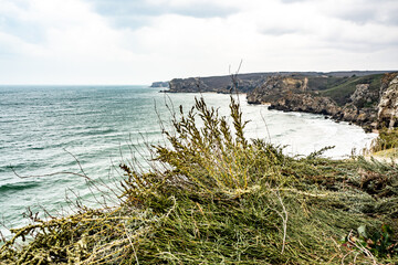 Mountains of steel and stones on the seashore. Wild beach. holidays, privacy,