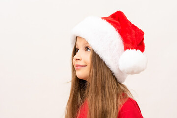 The child looks to the side. Wearing a new year's hat on your head.