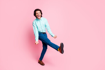 Full body photo of young excited man happy celebrate win victory fists hands scream shout yeah isolated over pink color background