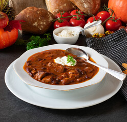 Spicy mexican bean soup with sour cream 