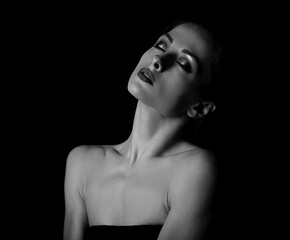 Beautiful elegant makeup woman with healthy neck and skin, nude shoulders on dark black background with empty copy space. Closeup portrait. Art.