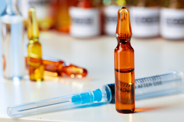 Medical vial with medication and syringe close up