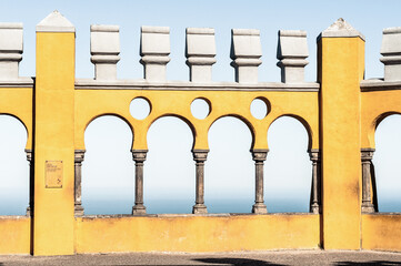 yellow arches looking over blue sky and ocean