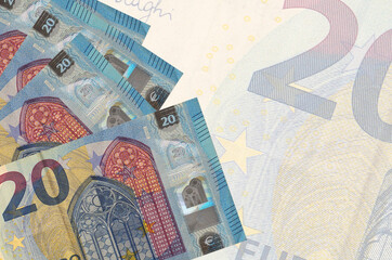 20 euro bills lies in stack on background of big semi-transparent banknote. Abstract business background