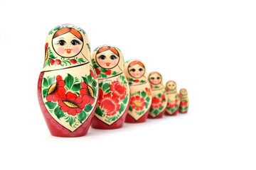 A set of nesting dolls lined up, the back ones are slightly blurred to show the depth of the image