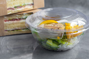 Home delivery in disposable dishes. Rice with salad and boiled chicken. Quarantine, isolation.