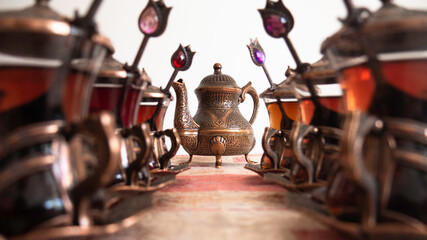 Turkish traditional teacups with spoons and teapot.