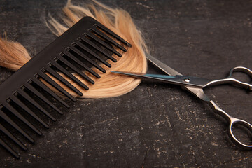 Hairdressing tools with curl on a black background